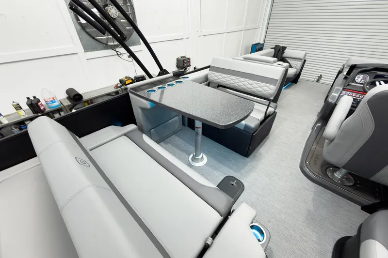 Slide: The Image of Luxurious interior of 2026 Godfrey Monaco 25' Tritoon with mid-table flip lounge. - 35