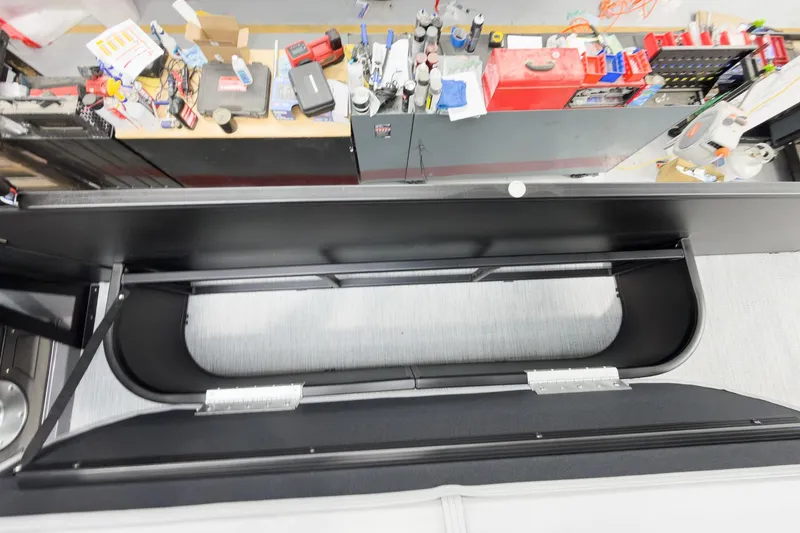 Slide: The Image of Overhead view of Godfrey Monaco 25' Tritoon's mid-table flip lounge, showcasing storage and workspace. - 39