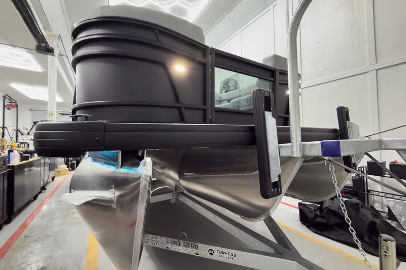 Slide: The Image of 2026 Godfrey Monaco 25' Tritoon boat in a workshop setting. - 4