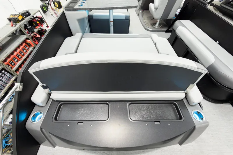 Slide: The Image of 2026 Godfrey Monaco 25' Tritoon interior with mid-table flip lounge seating. - 47