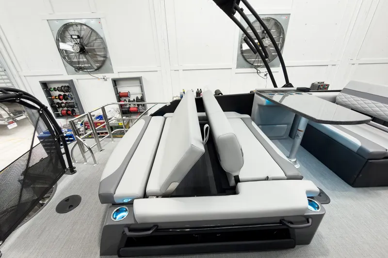 Slide: The Image of 2026 Godfrey Monaco 25' Tritoon with mid-table flip lounge, showcasing modern seating and design. - 48