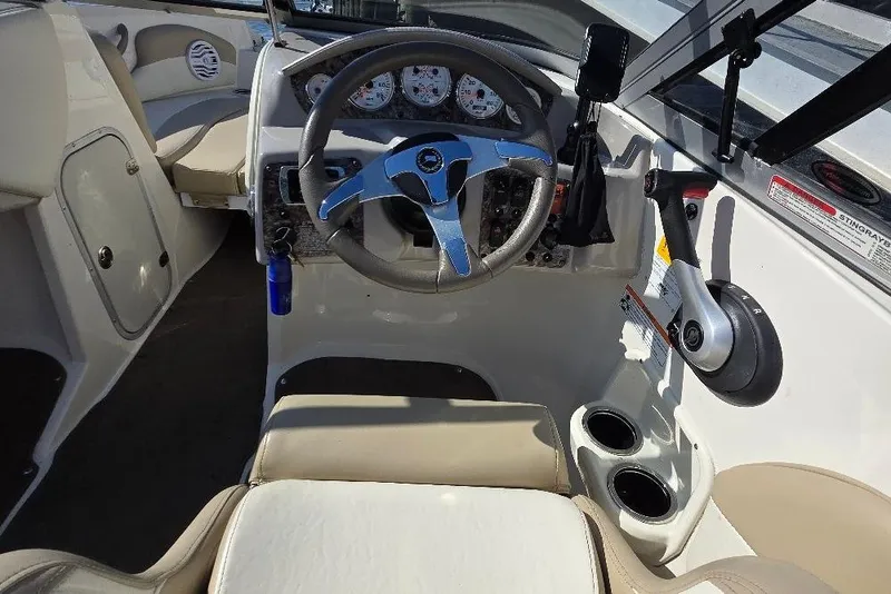 Slide: The Image of Interior of a 2014 Stingray 198 LX boat, featuring steering wheel and controls. - 10