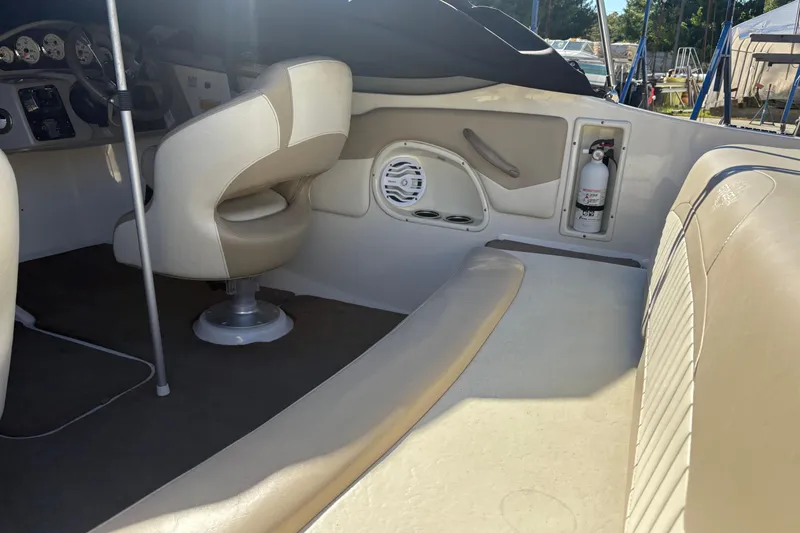 Slide: The Image of Interior of 2014 Stingray 198 LX boat with seating, steering wheel, and fire extinguisher. - 12