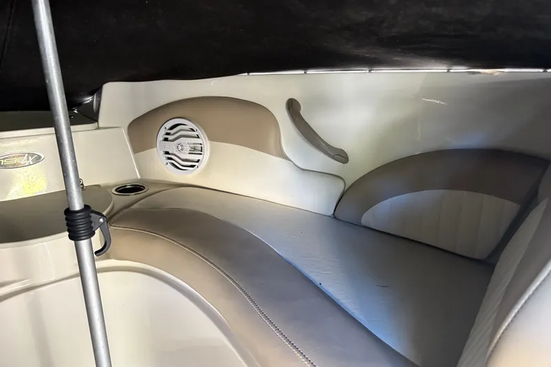 Slide: The Image of Interior of a 2014 Stingray 198 LX boat, featuring seating and speaker. - 15