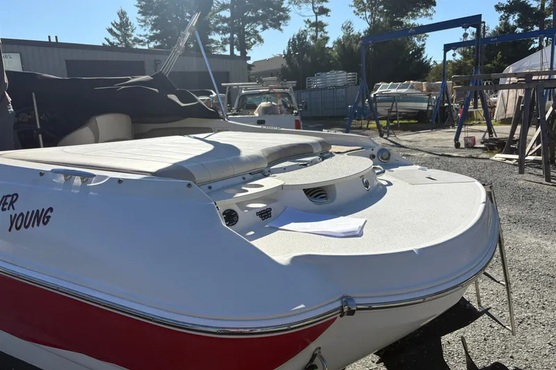 Slide: The Image of 2014 Stingray 198 LX boat in a sunny outdoor setting, rear view. - 3