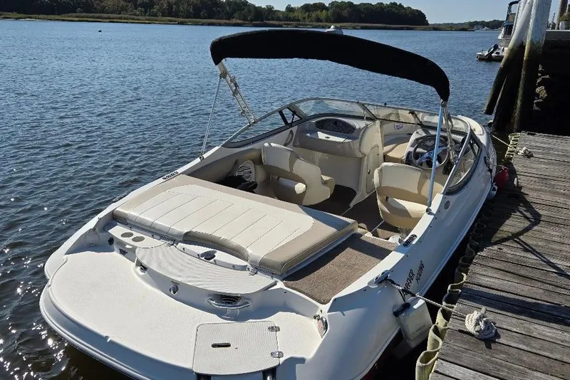 Slide: The Image of 2014 Stingray 198 LX boat docked on a sunny day by the water. - 5