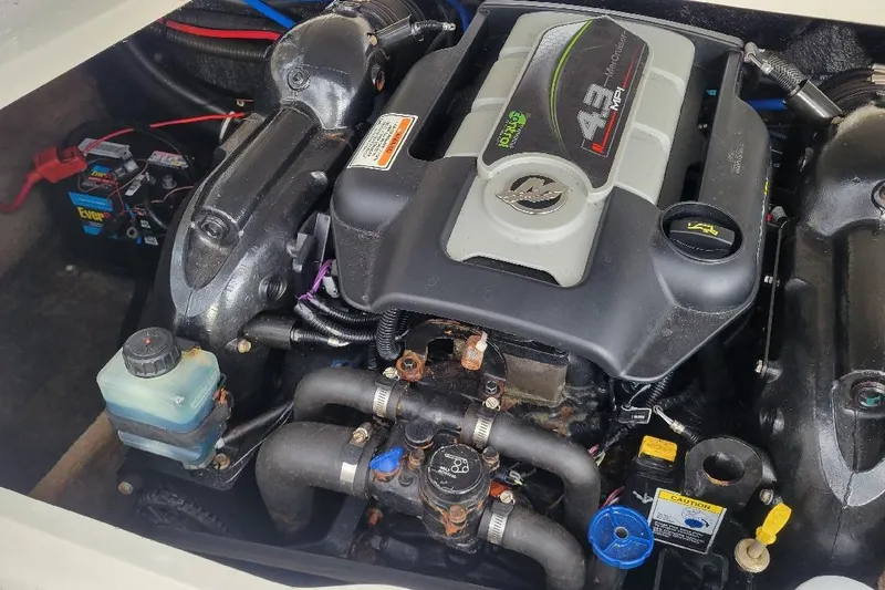 Slide: The Image of Engine of a 2014 Stingray 198 LX boat, showcasing detailed components and layout. - 6