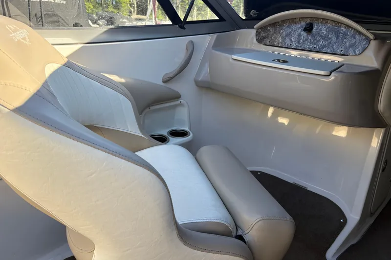 Slide: The Image of 2014 Stingray 198 LX boat interior with beige seating and storage compartment. - 8