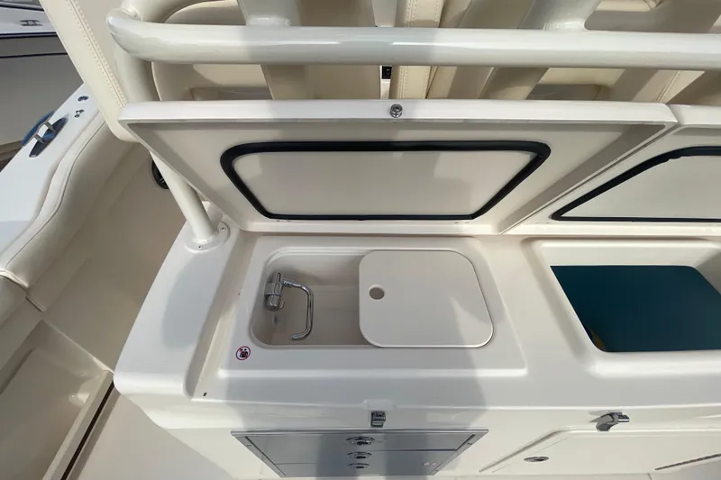 Slide: The Image of 2026 Grady-White Canyon 326 boat sink and storage area. - 17