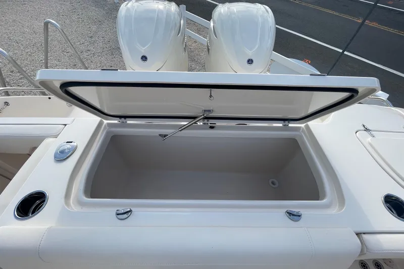 Slide: The Image of 2026 Grady-White Canyon 326 boat with open storage compartment and dual engines. - 23