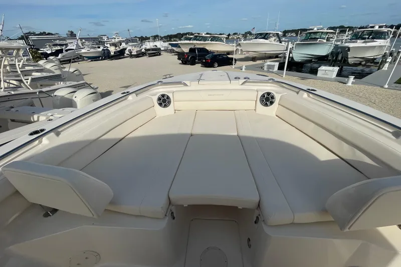 Slide: The Image of 2026 Grady-White Canyon 326 boat interior with spacious seating at a marina. - 5