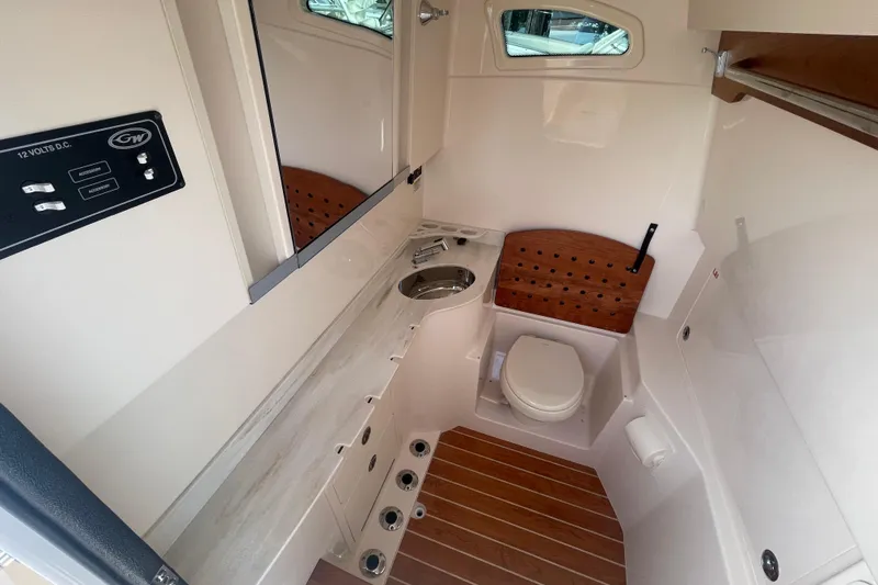 Slide: The Image of 2026 Grady-White Canyon 326 boat interior with toilet, sink, and wooden accents. - 8