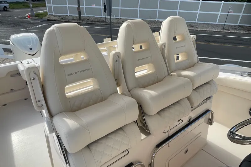 Slide: The Image of 2026 Grady-White Canyon 326 boat seats, luxurious white leather interior. - 9