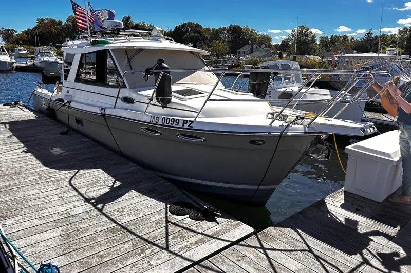 The Image of 2014 Cutwater C-28 boat docked at a marina with clear skies. - 0