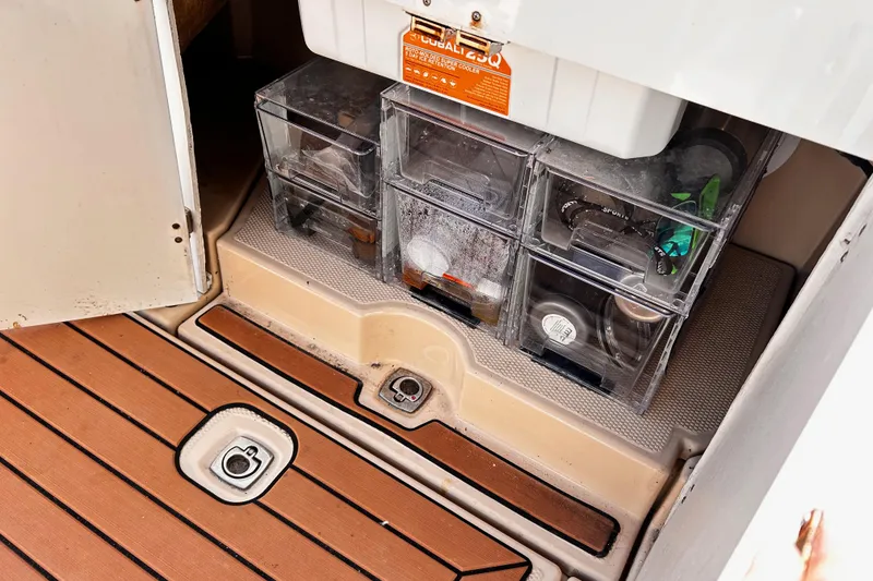 Slide: The Image of Storage compartment on a 2014 Cutwater C-28 boat with organized containers. - 11