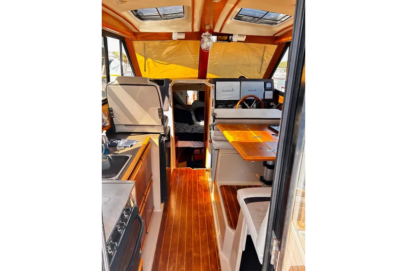 Slide: The Image of Interior of 2014 Cutwater C-28 boat with wood flooring and navigation equipment. - 13