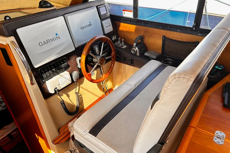 Slide: The Image of 2014 Cutwater C-28 helm with Garmin navigation, wood accents, and comfortable seating. - 16