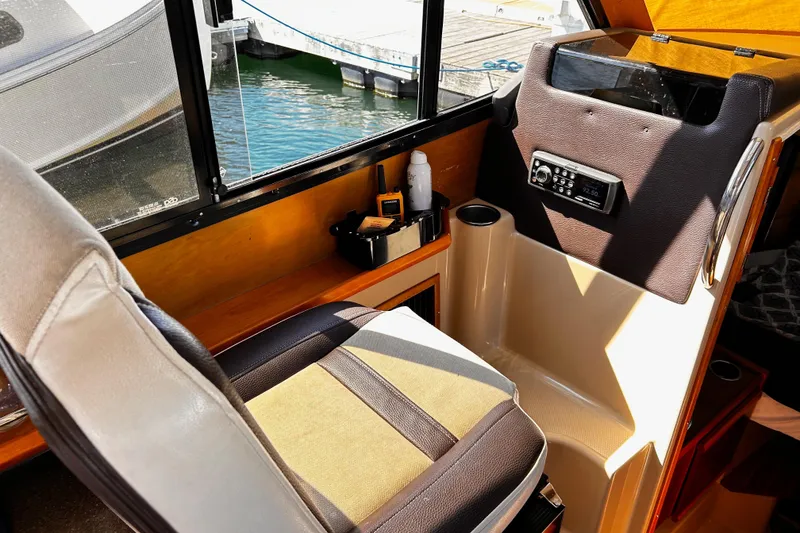 Slide: The Image of Interior of a 2014 Cutwater C-28 boat with helm seat and control panel. - 18