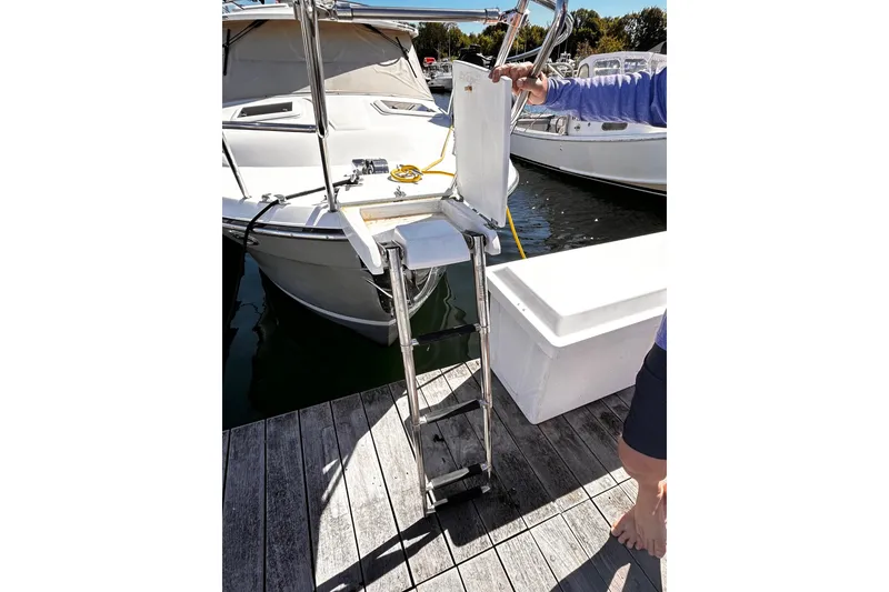 Slide: The Image of 2014 Cutwater C-28 boat with boarding ladder on dock. - 2