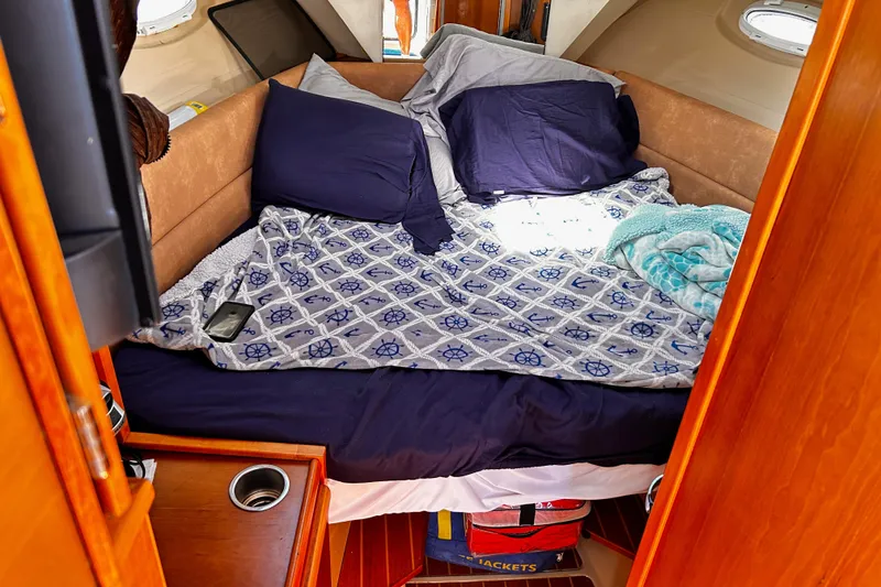 Slide: The Image of Cozy cabin interior of 2014 Cutwater C-28 boat with nautical-themed bedding. - 20