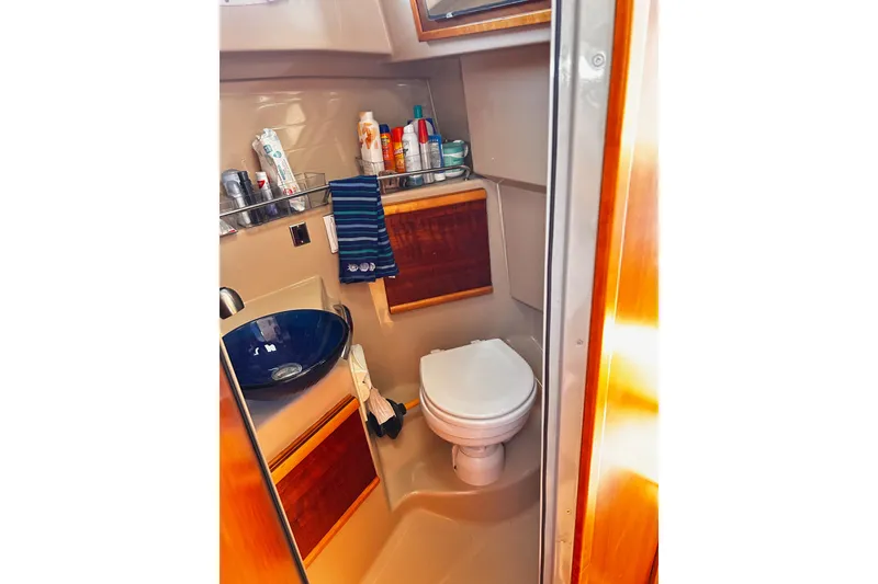 Slide: The Image of 2014 Cutwater C-28 boat bathroom with sink, toilet, and toiletries. - 25