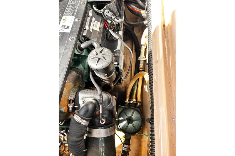 Slide: The Image of Engine compartment of a 2014 Cutwater C-28 boat, showcasing hoses and components. - 29