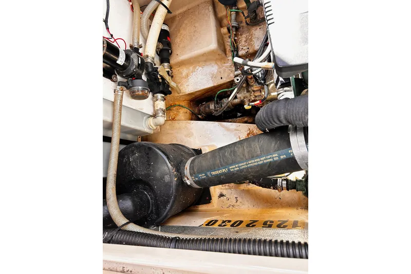 Slide: The Image of Engine compartment of a 2014 Cutwater C-28 boat, showing hoses and mechanical components. - 30