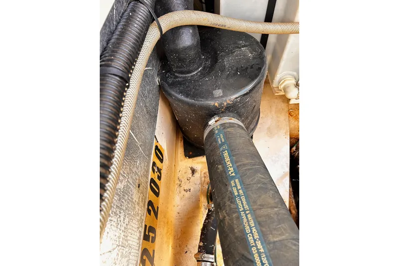 Slide: The Image of Engine compartment of a 2014 Cutwater C-28 boat, showing hoses and components. - 33