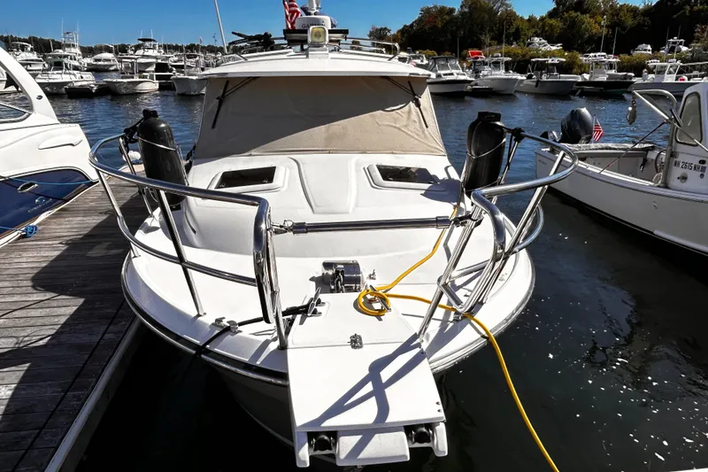 Slide: The Image of 2014 Cutwater C-28 boat docked at marina, surrounded by other vessels. - 5