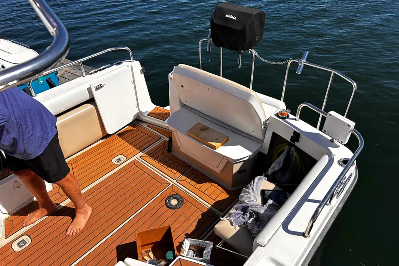 Slide: The Image of 2014 Cutwater C-28 boat deck with wooden flooring and seating area. - 9