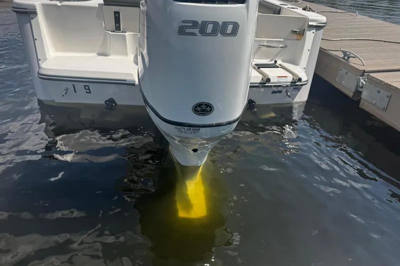 Slide: The Image of 2023 Sea Born FX22 Bay boat engine submerged in water at dock. - 16