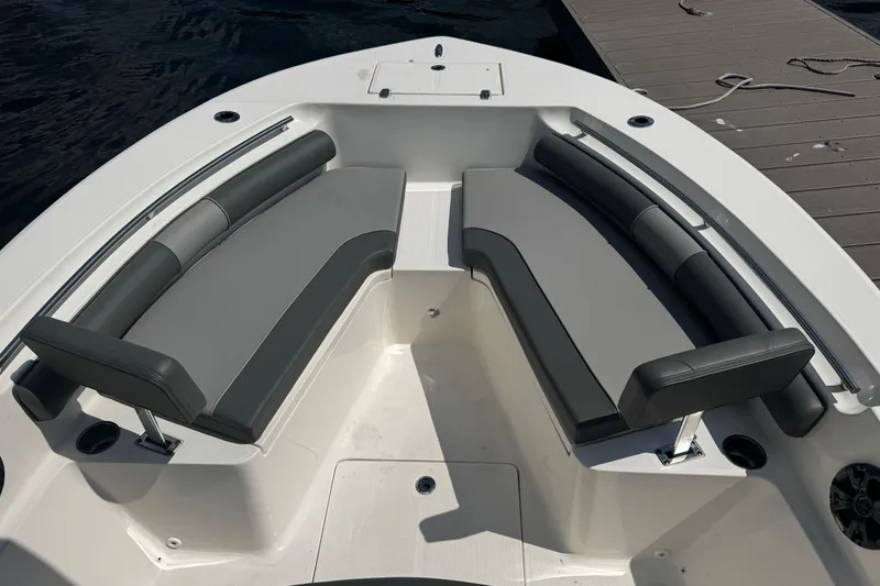 Slide: The Image of 2023 Sea Born FX22 Bay boat interior with cushioned seating and storage compartments. - 3