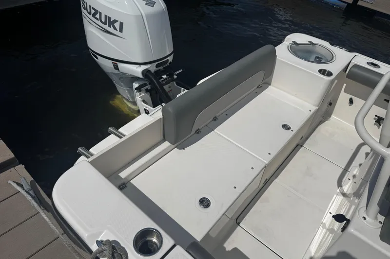 Slide: The Image of 2023 Sea Born FX22 Bay boat with Suzuki outboard motor, docked on water. - 7