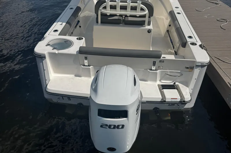 Slide: The Image of 2023 Sea Born FX22 Bay boat with powerful 200 HP engine docked at marina. - 8