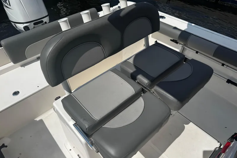 Slide: The Image of 2023 Sea Born FX22 Bay boat interior with cushioned seating and rod holders. - 9