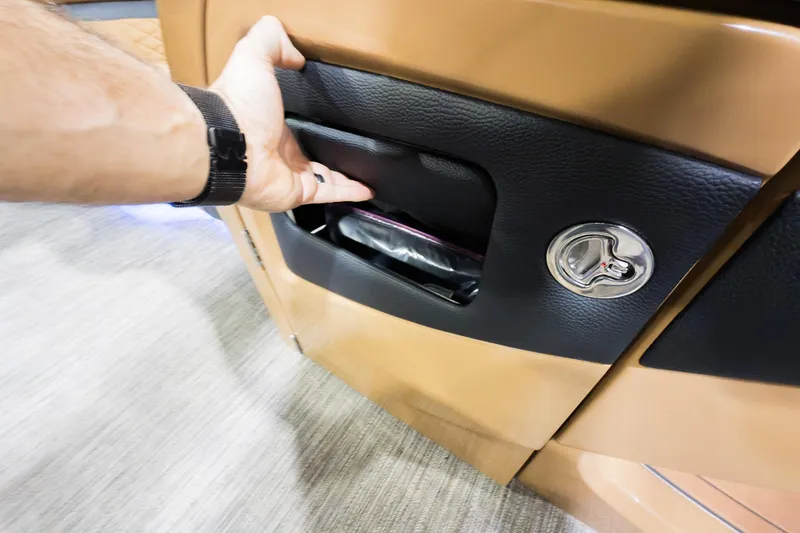 Slide: The Image of Hand accessing storage compartment in 2026 Godfrey Monaco 255 Mid-Table Single Flip Lounge. - 12