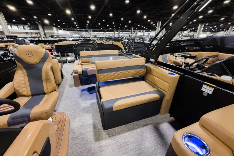 Slide: The Image of Luxurious 2026 Godfrey Monaco 255 boat interior with tan and gray seating, showcased indoors. - 14