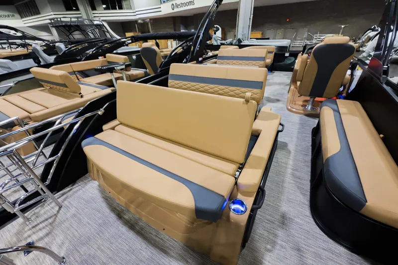 Slide: The Image of 2026 Godfrey Monaco 255 boat interior with tan and gray seating, mid-table lounge. - 23