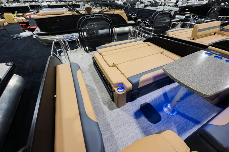 Slide: The Image of 2026 Godfrey Monaco 255 boat interior with tan seating and a sleek table. - 25