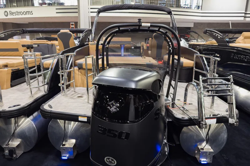 Slide: The Image of 2026 Godfrey Monaco 255 pontoon boat with Suzuki 350 engine at a showroom display. - 3