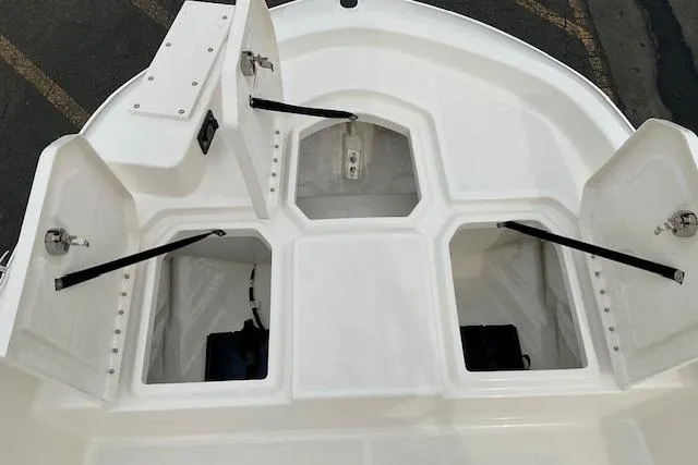 Slide: The Image of 2025 Bayliner Trophy T18 boat storage compartments open, showcasing spacious design. - 11