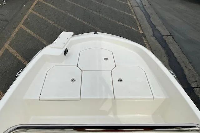 Slide: The Image of 2025 Bayliner Trophy T18 boat deck, featuring storage compartments and sleek design. - 12