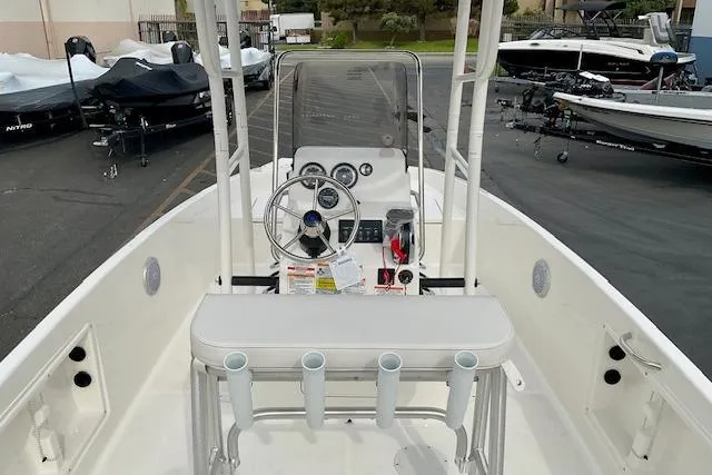 Slide: The Image of 2025 Bayliner Trophy T18 boat interior with steering console and rod holders. - 16