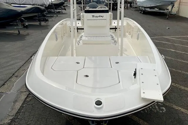 Slide: The Image of 2025 Bayliner Trophy T18 boat, white deck, parked in a marina. - 19