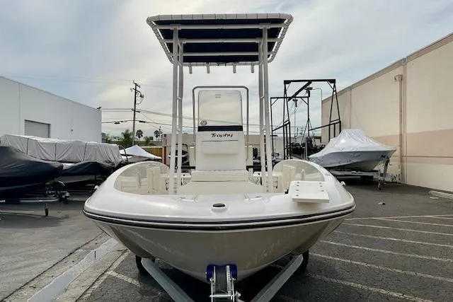 Slide: The Image of 2025 Bayliner Trophy T18 boat on trailer in outdoor storage area. - 6