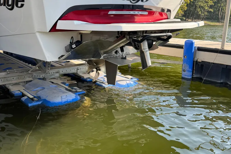 Slide: The Image of 2022 Tigé 25ZX boat interior with red and white seating on the water. - 4