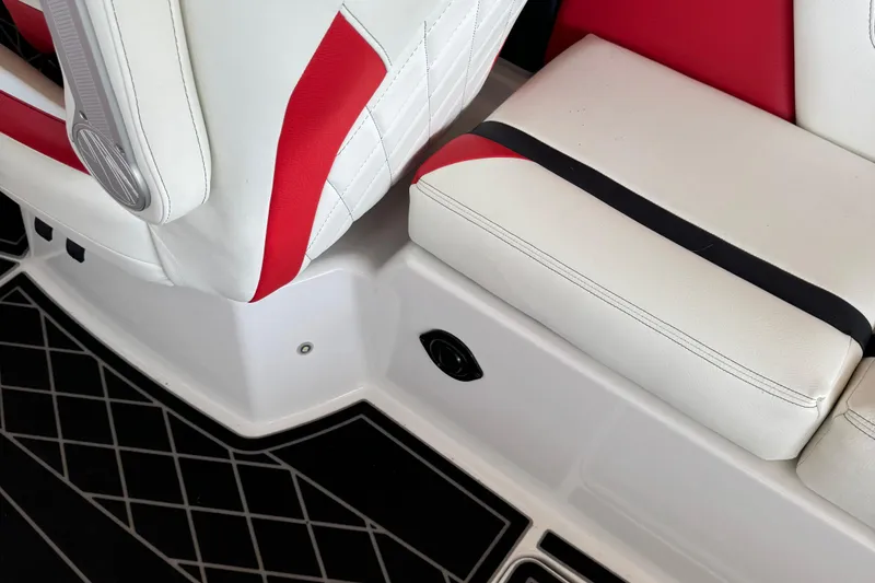 Slide: The Image of 2022 Tigé 25ZX boat interior with red and white seating, diamond-patterned flooring. - 5