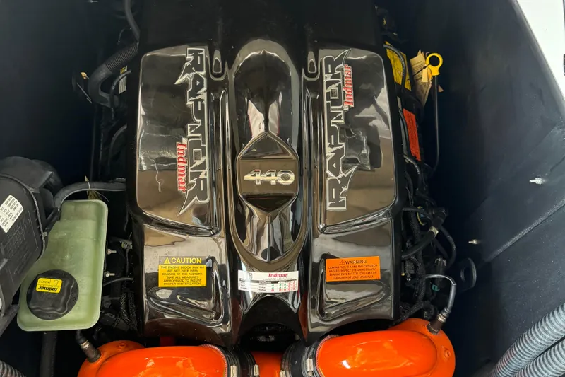 Slide: The Image of 2022 Tigé 25ZX boat interior with speakers and wakeboard rack on a sunny day. - 6