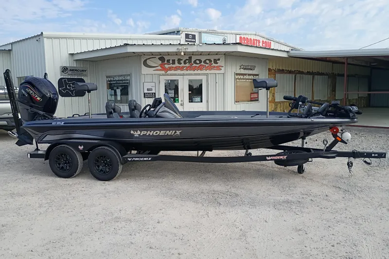 The Image of 2026 Phoenix 921 ELITEX boat on trailer outside dealership, showcasing sleek design and features. - 1