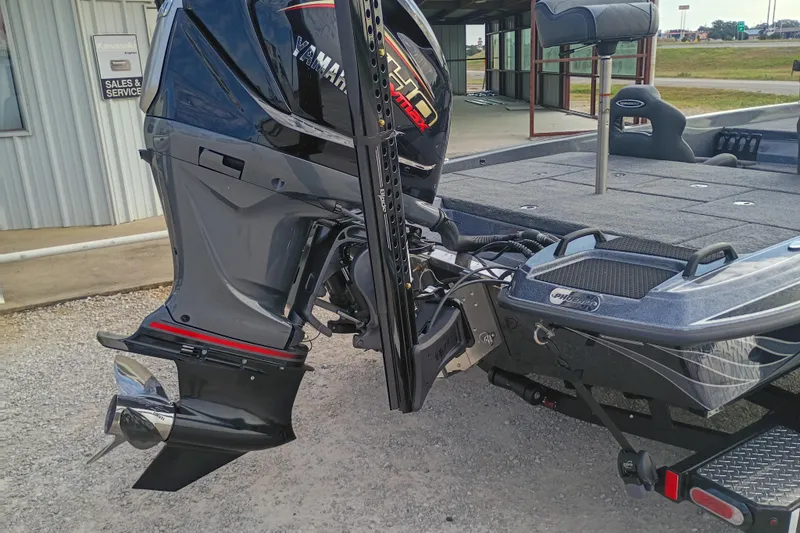 Slide: The Image of 2026 Phoenix 921 ELITEX boat with Yamaha outboard motor, parked near sales and service building. - 10